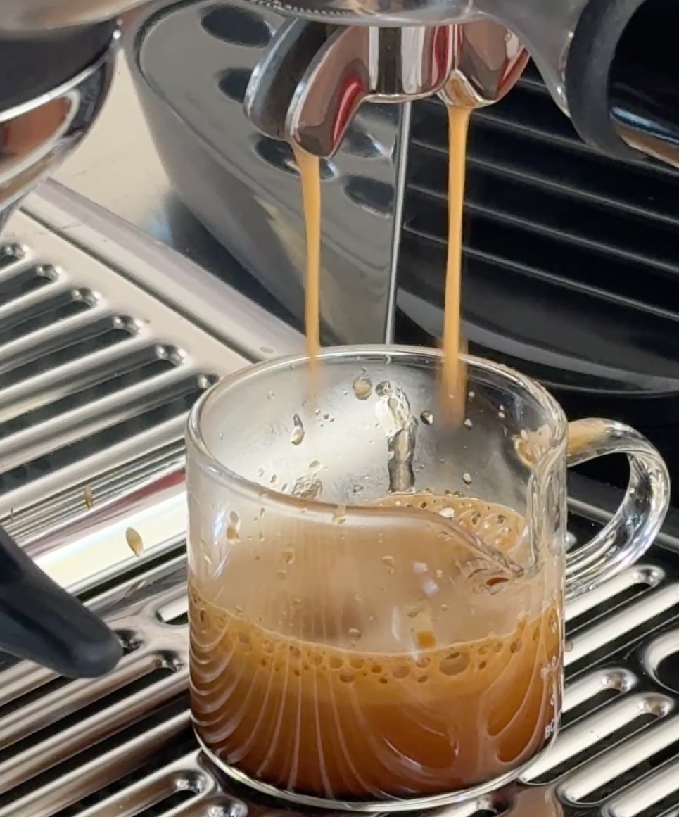 Fresh espresso being poured into a cup